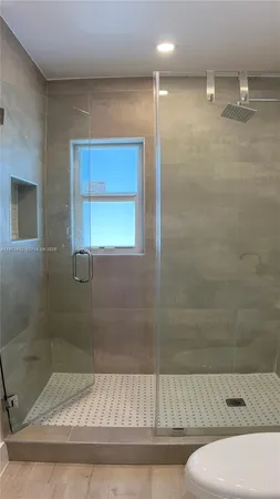 a bathroom with a shower and toilet
