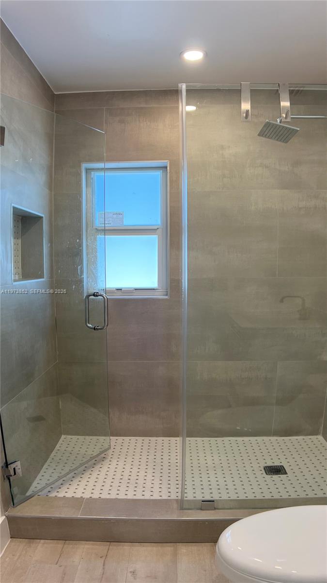 2800 Southwest 25th Street, Unit 1 Miami, FL 33133 - Photo 28 of 48 a bathroom with a shower and a toilet