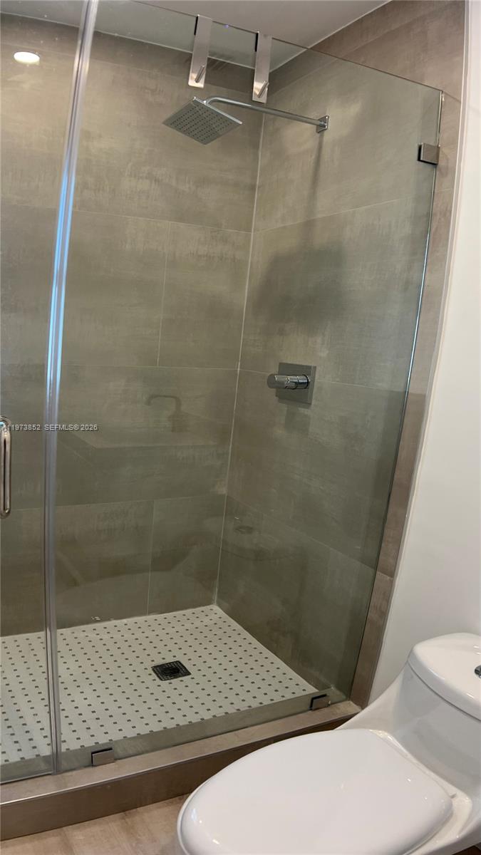 2800 Southwest 25th Street, Unit 1 Miami, FL 33133 - Photo 29 of 48 a bathroom with a shower and toilet