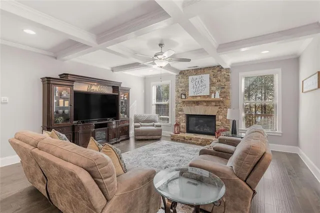 a kitchen with granite countertop kitchen island stainless steel appliances and living room