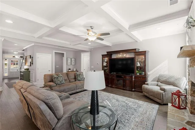 a kitchen with a sink a stove a refrigerator and white cabinets