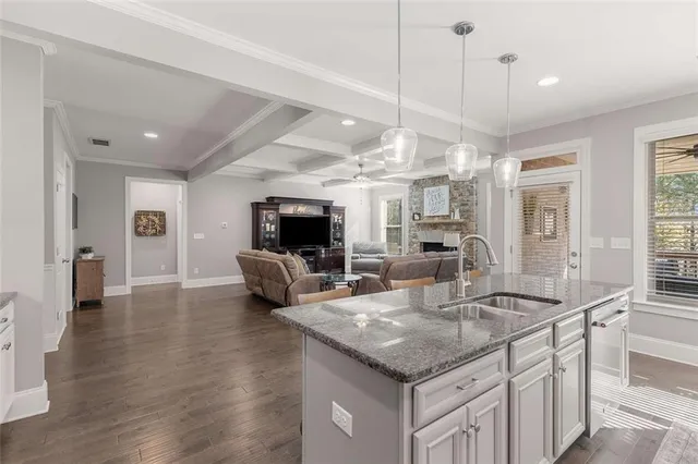 a kitchen with granite countertop a stove and a sink