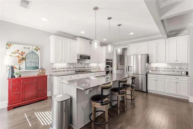 a view of a kitchen with a sink and dishwasher with wooden floor