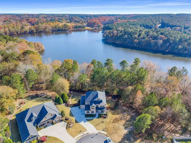 an aerial view of a house with a lake view