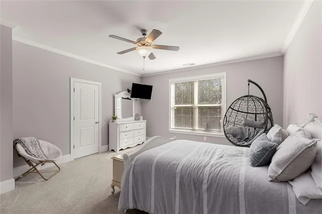 a spacious bedroom with a bed and a table in it