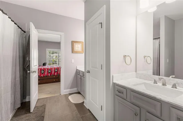 a spacious bedroom with a bed and a chandelier