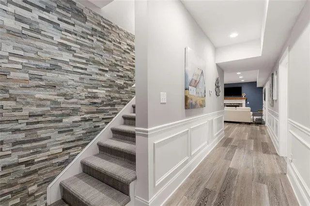 a bathroom with a tub sink and mirror