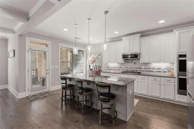a kitchen with stainless steel appliances granite countertop a stove and refrigerator