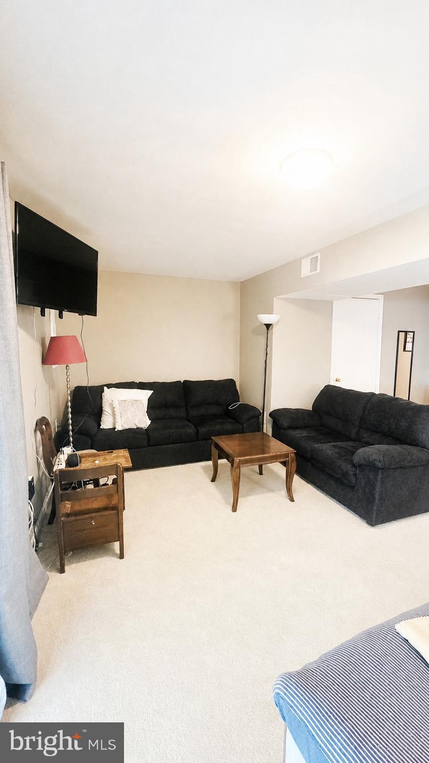 15370 Inlet Place Dumfries, VA 22025 - Photo 21 of 30 a living room with furniture and a flat screen tv