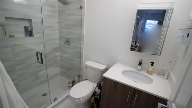 a bathroom with a sink toilet and shower