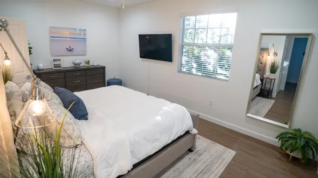 a bedroom with a bed and a potted plant