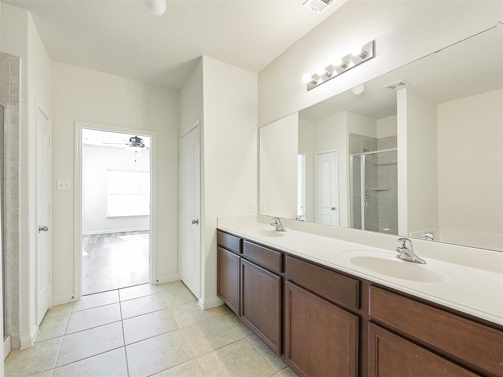1402 Englemann Drive Princeton, TX 75407 - Photo 17 of 33 Ensuite bath with double vanity and linen closet