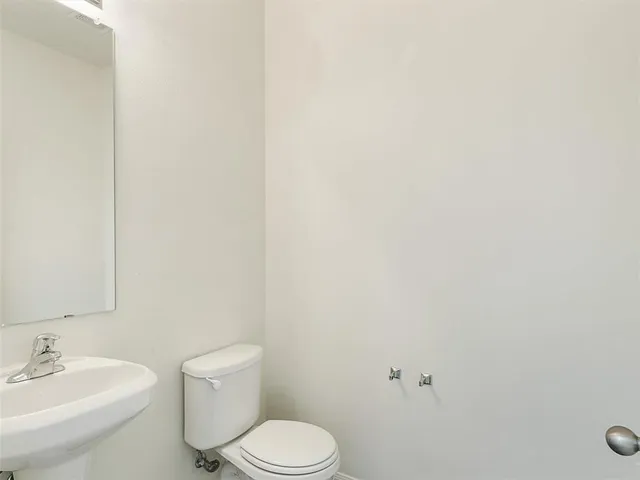 a white toilet sitting next to a white sink