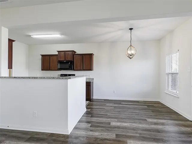 a view of a kitchen with microwave and cabinets