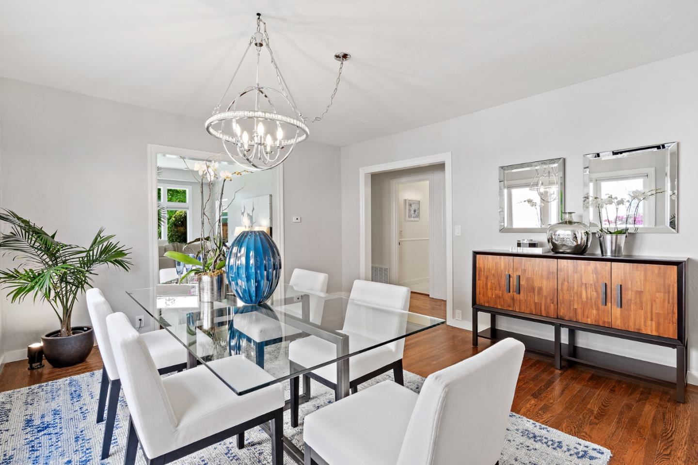 2218 Hale Drive Burlingame, CA 94010 - Photo 12 of 45 a dining room with furniture a chandelier and wooden floor