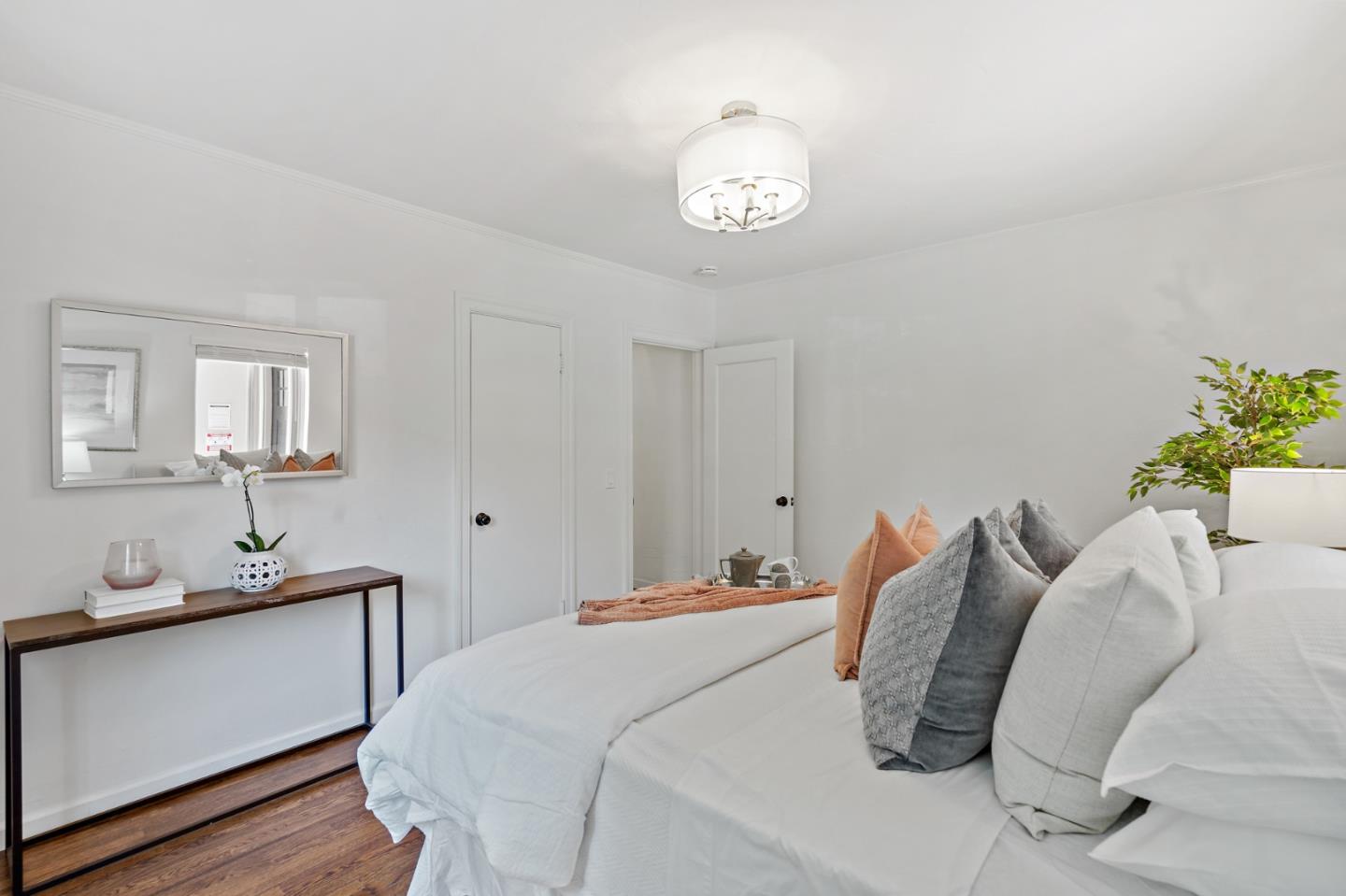 2218 Hale Drive Burlingame, CA 94010 - Photo 30 of 45 a bedroom with a bed and a chandelier