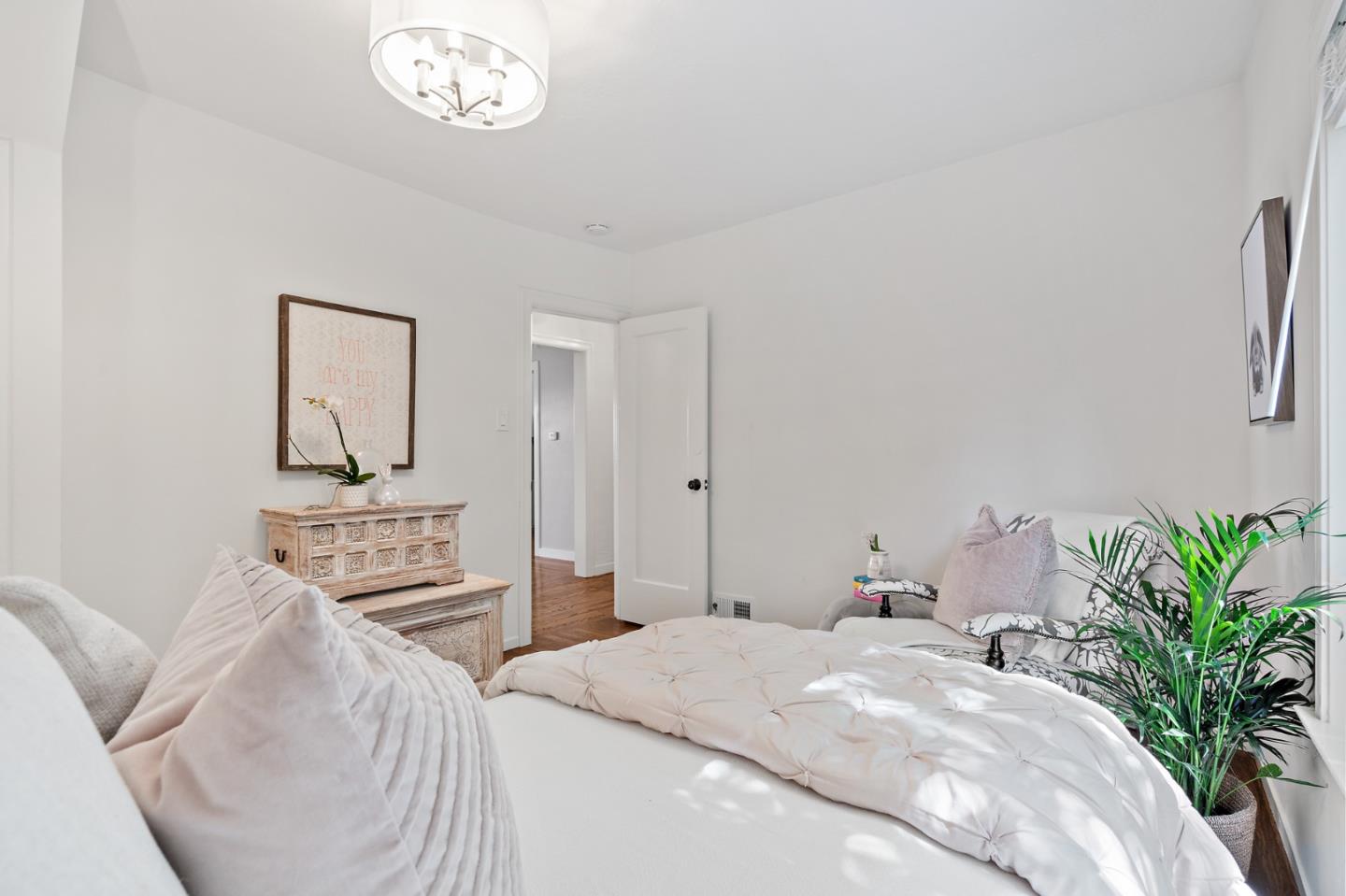 2218 Hale Drive Burlingame, CA 94010 - Photo 32 of 45 a bedroom with a bed and a chandelier