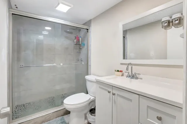 a bathroom with a sink toilet and shower