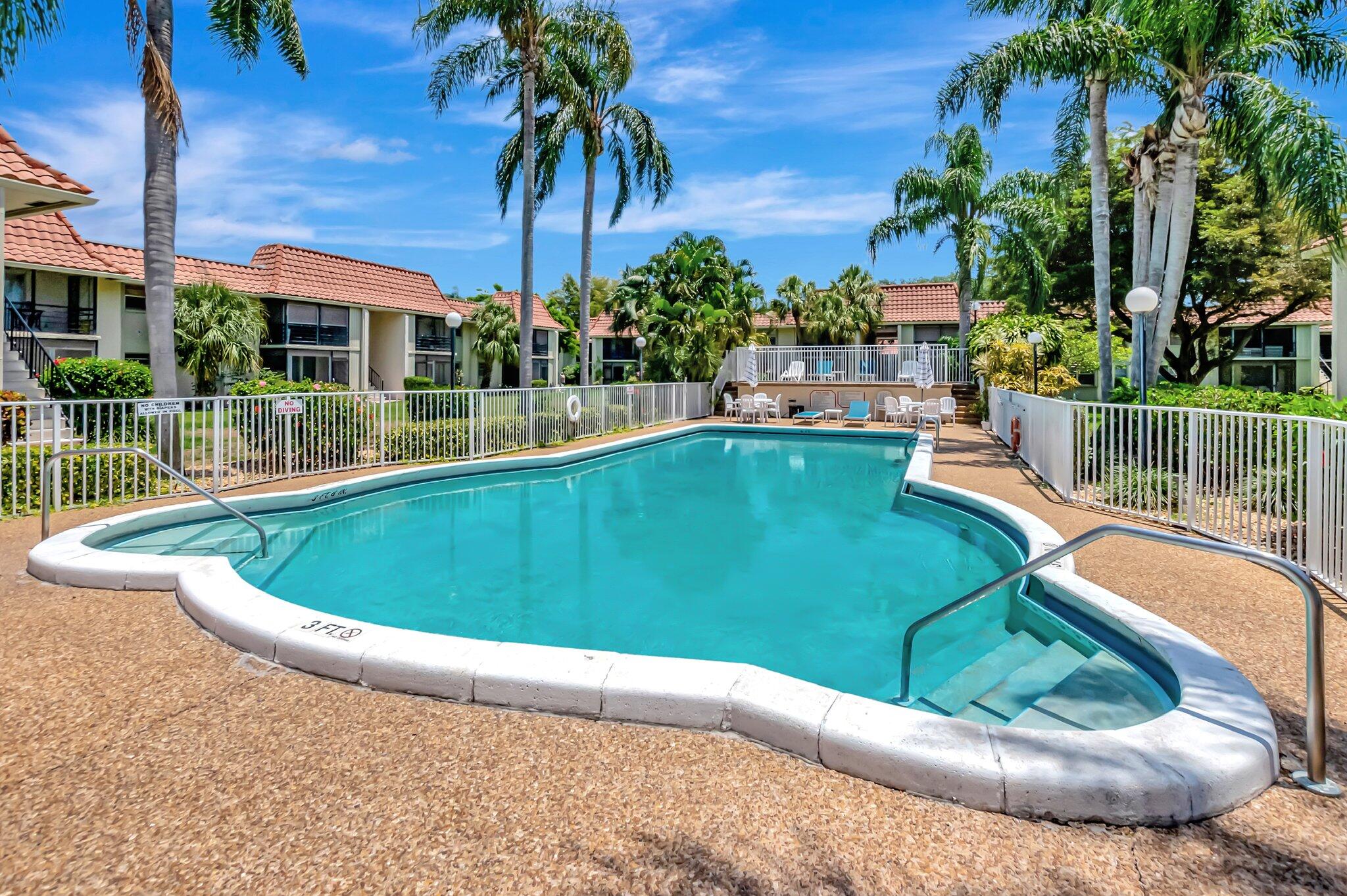 1124 Northwest 13th Street, Unit 208 Boca Raton, FL 33486 - Photo 23 of 23 a view of a swimming pool with a patio