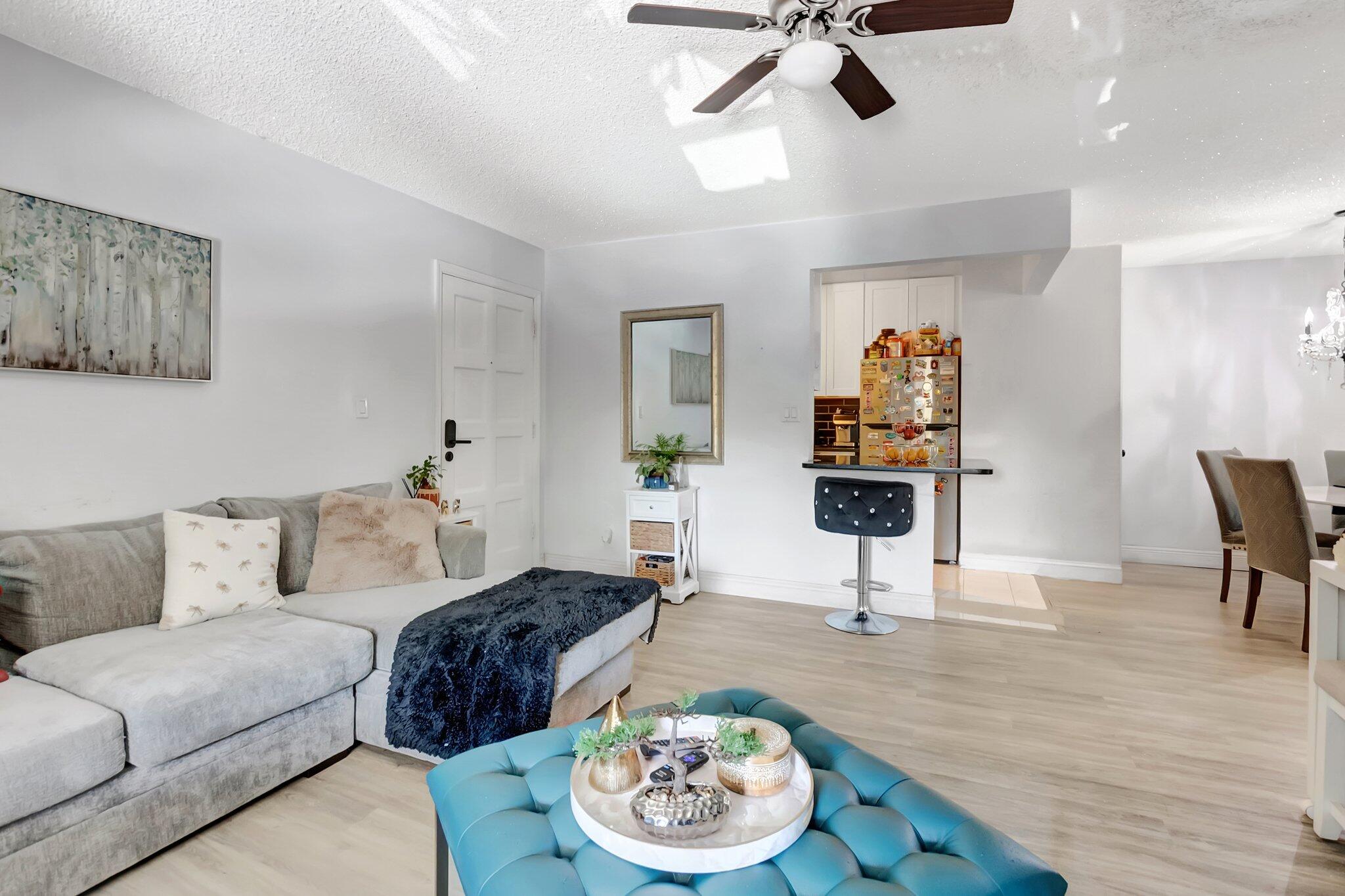 1124 Northwest 13th Street, Unit 208 Boca Raton, FL 33486 - Photo 4 of 23 a living room with furniture and a table
