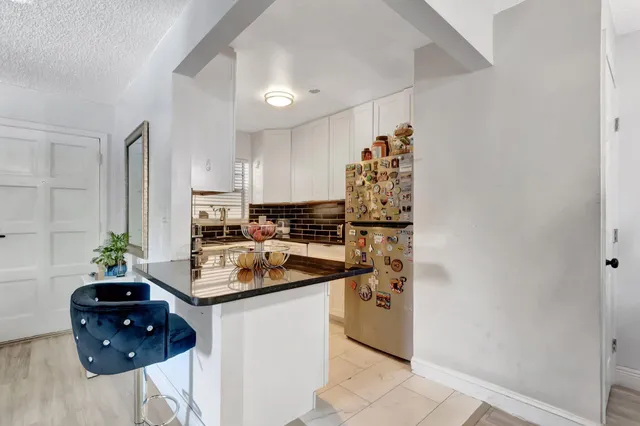 a kitchen with a refrigerator and a stove