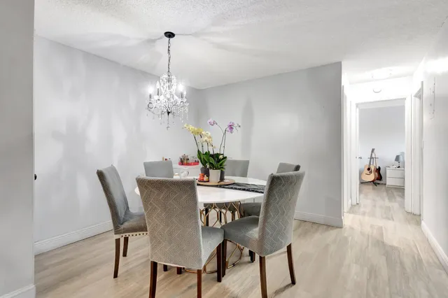 a view of a dining room with furniture wooden floor and a chandelier