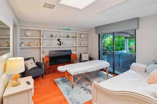 a bedroom with furniture and a wooden floor