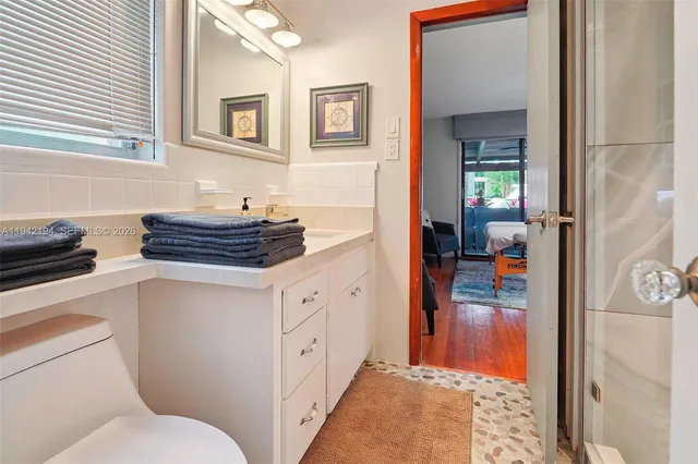 a bathroom with a toilet a sink and a mirror