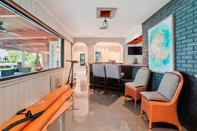 a living room with furniture a flat screen tv and a large window