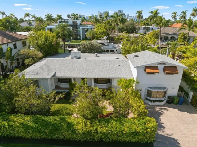 an aerial view of a house with a yard large tree and a outdoor view