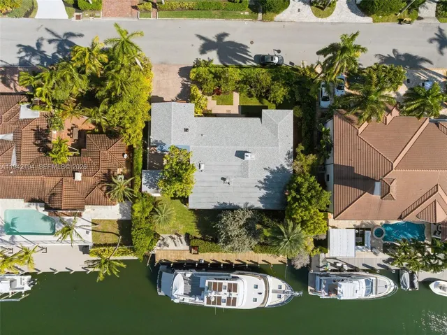 an aerial view of a house with a lake view
