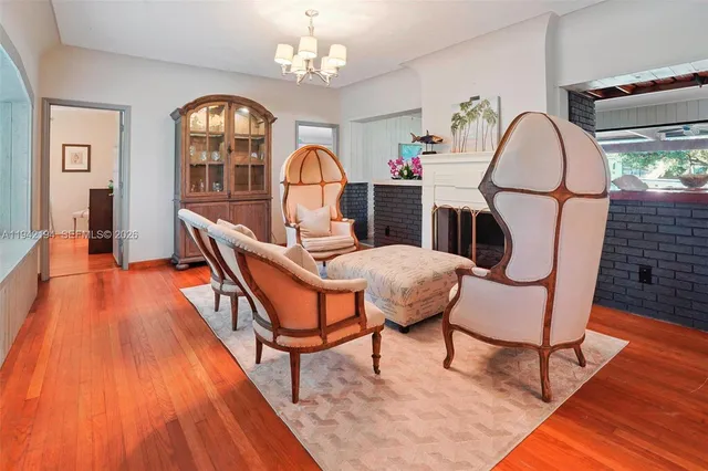 a living room with furniture a rug and wooden floor