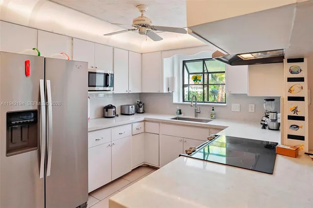 a kitchen with stainless steel appliances a refrigerator sink and cabinets