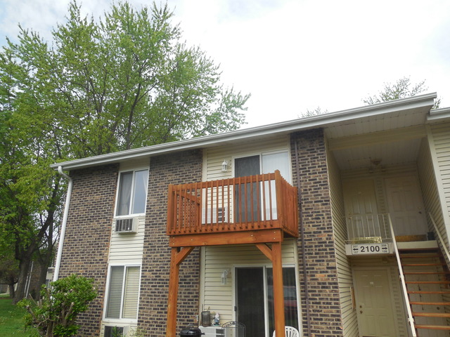 2100 Light Road, Unit 207 Oswego, IL 60543 - Photo 2 of 14 a front view of a house with balcony