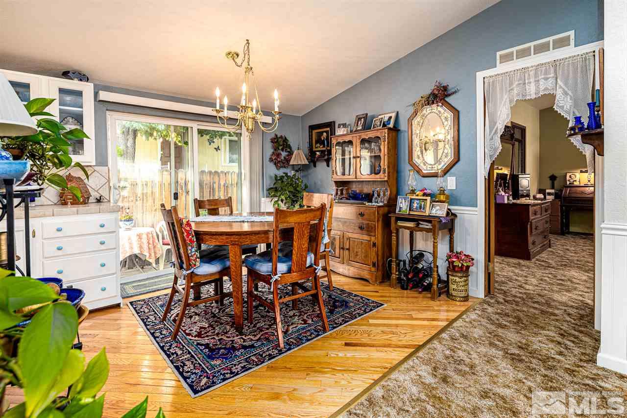 2751 Larkspur Street Reno, NV 89512 - Photo 12 of 24 a view of a dining room and livingroom with furniture a rug a painting and a chandelier