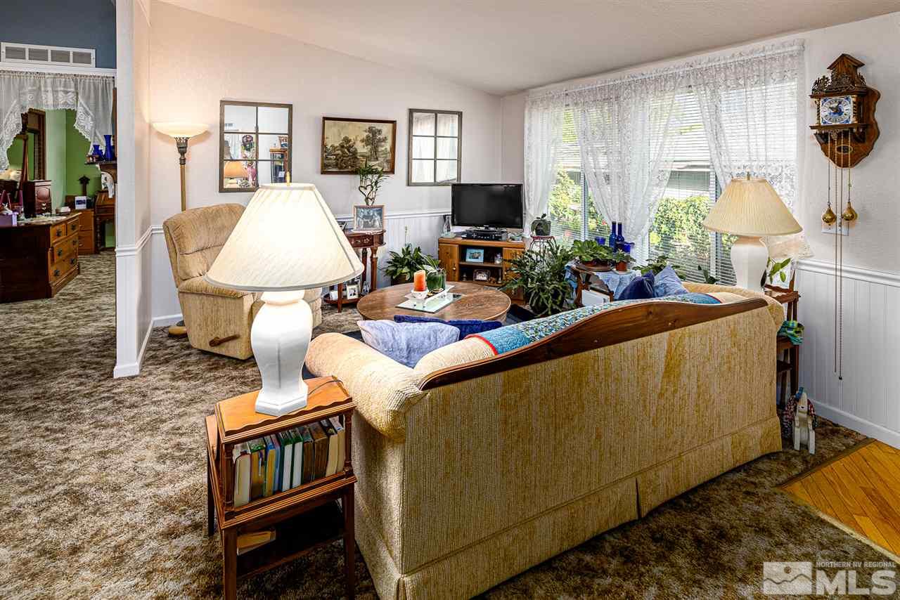 2751 Larkspur Street Reno, NV 89512 - Photo 13 of 24 a living room with furniture a flat screen tv and a table