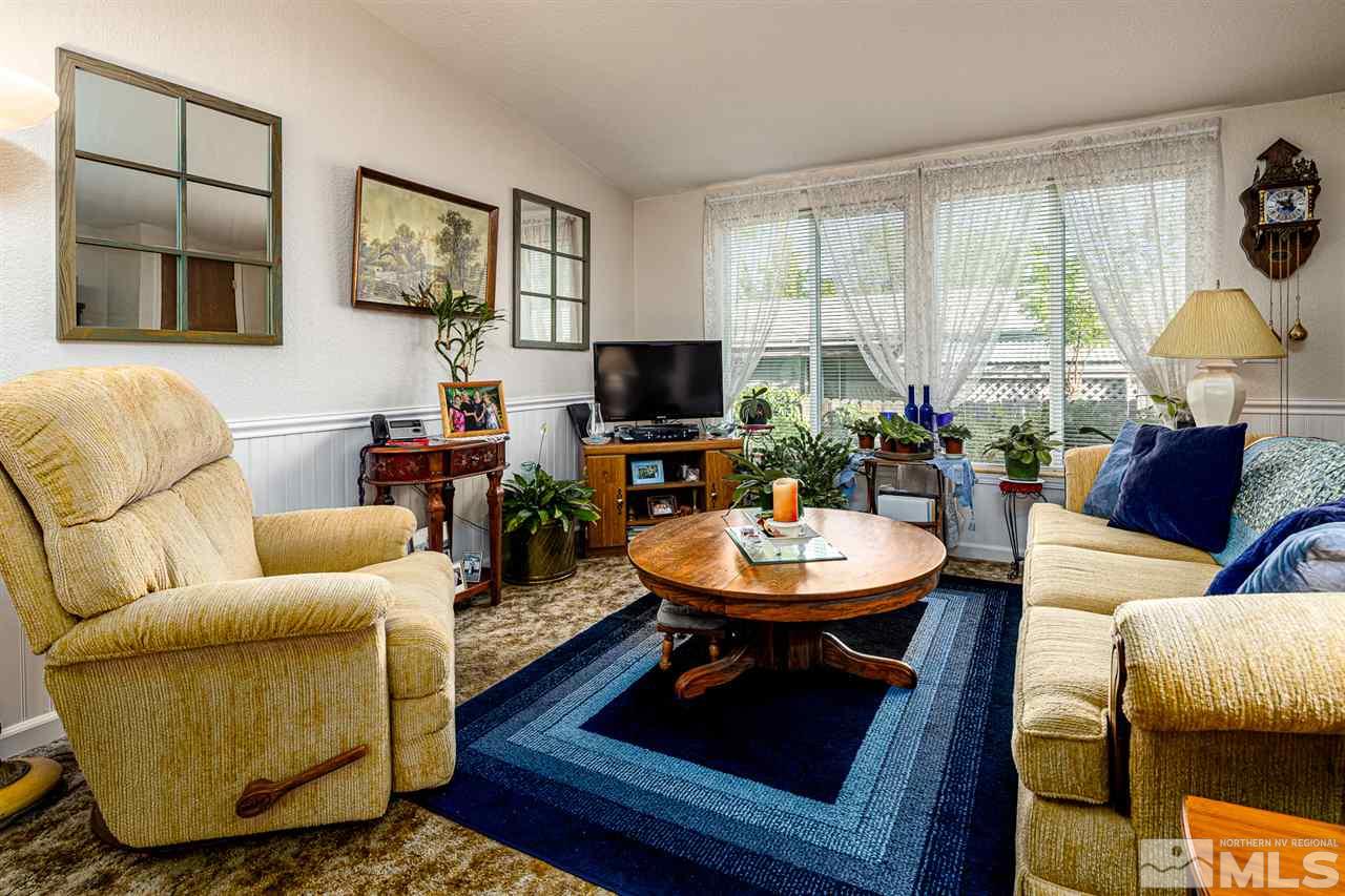 2751 Larkspur Street Reno, NV 89512 - Photo 14 of 24 a living room with fireplace furniture and a large window