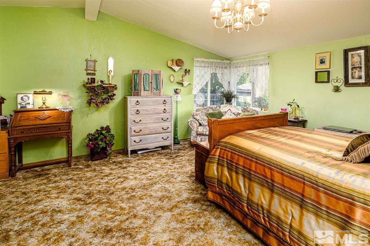 2751 Larkspur Street Reno, NV 89512 - Photo 17 of 24 a bedroom with a bed and a mirror on the dresser