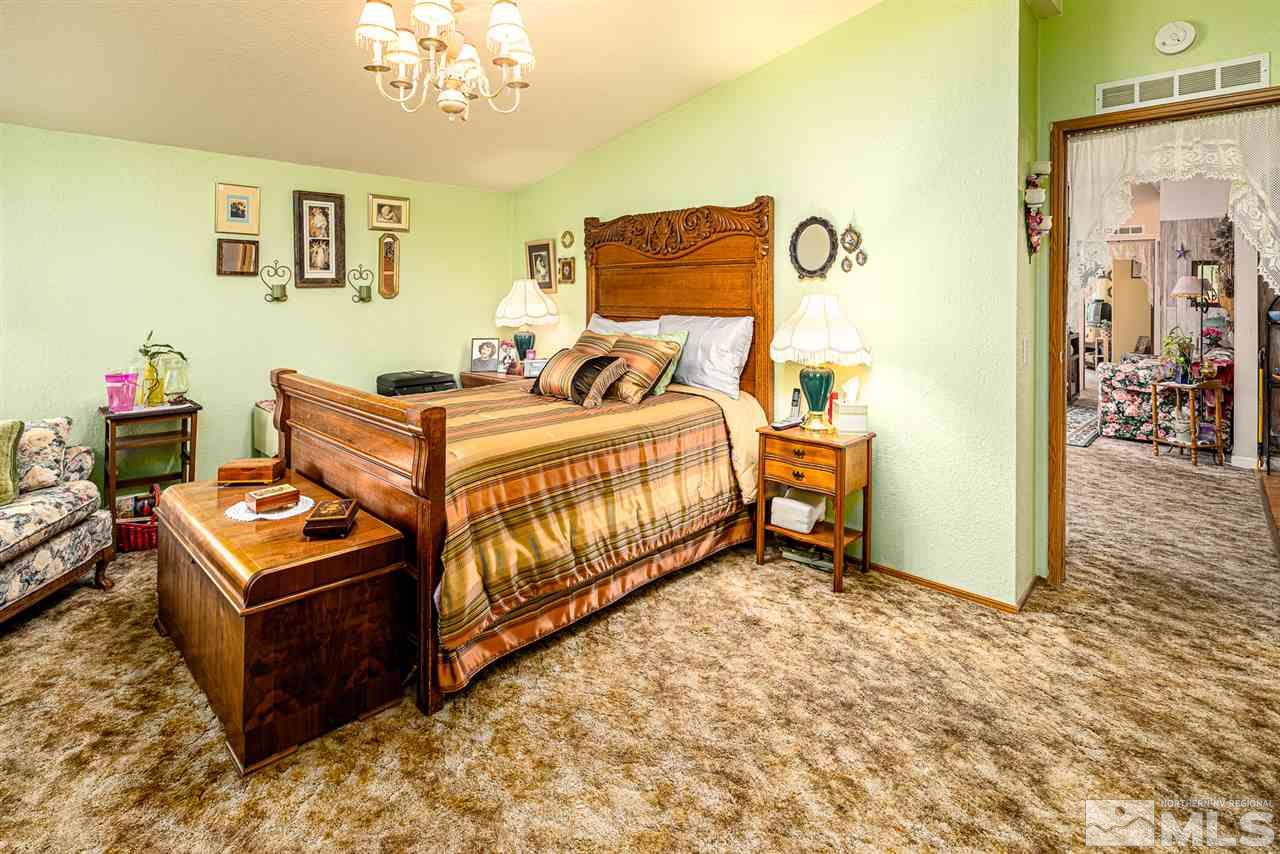 2751 Larkspur Street Reno, NV 89512 - Photo 18 of 24 a bed room with a bed and a dresser