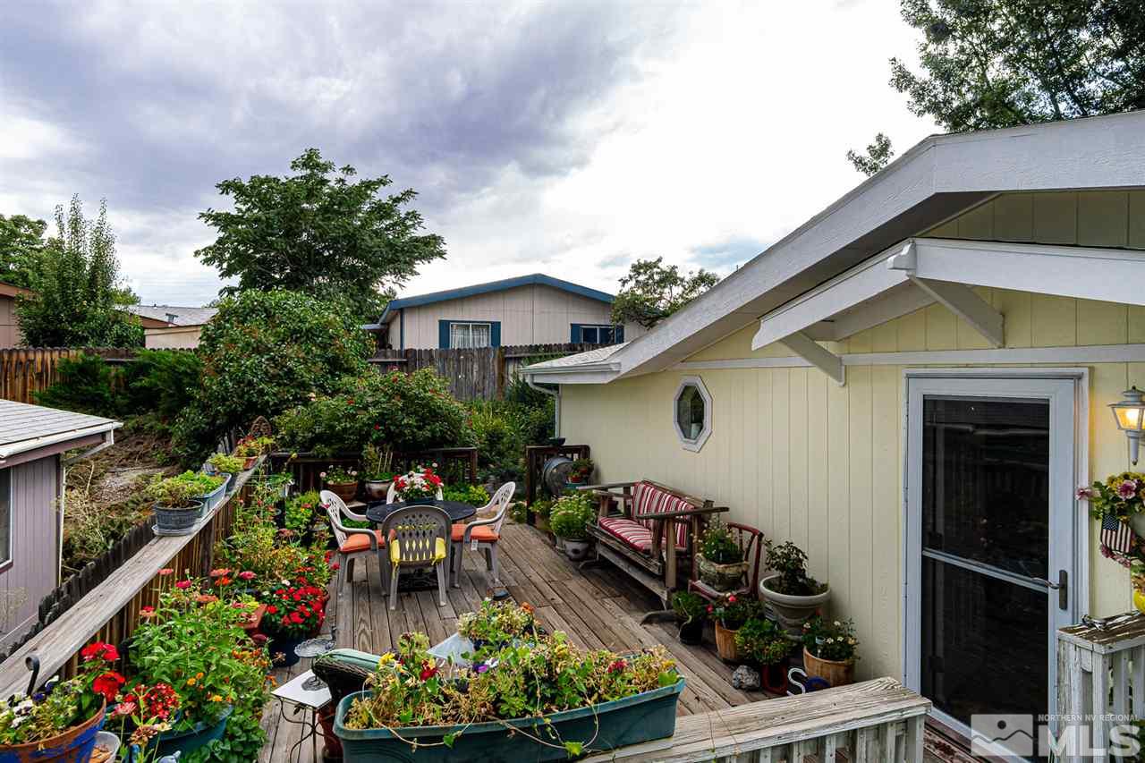 2751 Larkspur Street Reno, NV 89512 - Photo 5 of 24 a front view of a house with a yard and potted plants