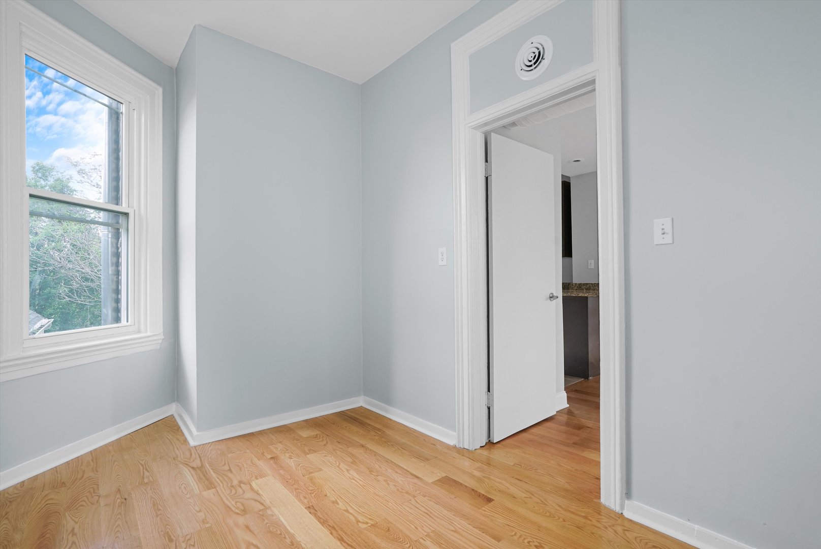 Undisclosed Address Chicago, IL 60622 - Photo 11 of 17 a view of an empty room with wooden floor and a window