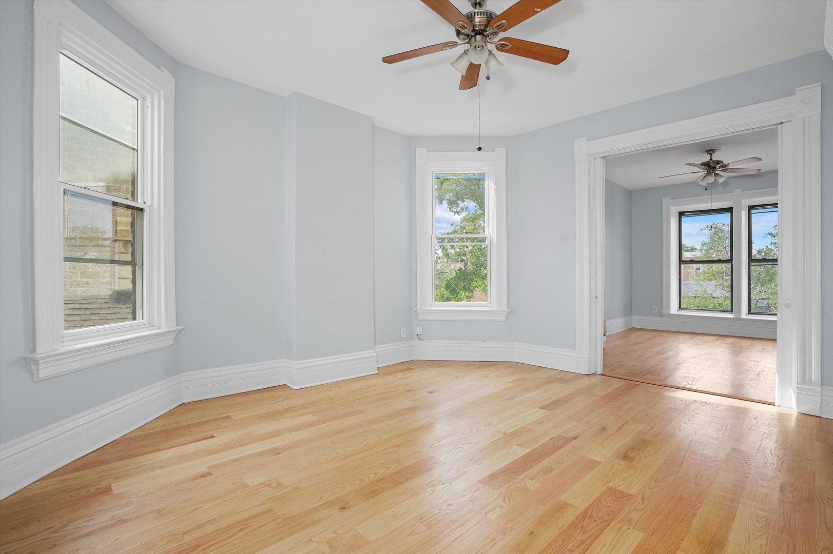 Undisclosed Address Chicago, IL 60622 - Photo 7 of 17 a view of an empty room with a window and wooden floor