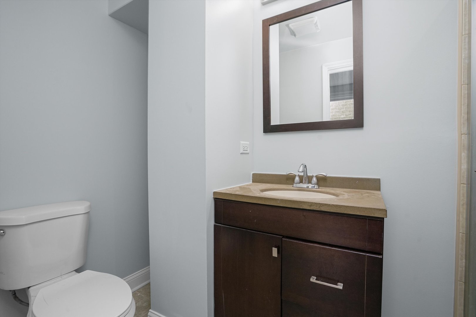 Undisclosed Address Chicago, IL 60622 - Photo 10 of 17 a bathroom with a toilet a sink and mirror