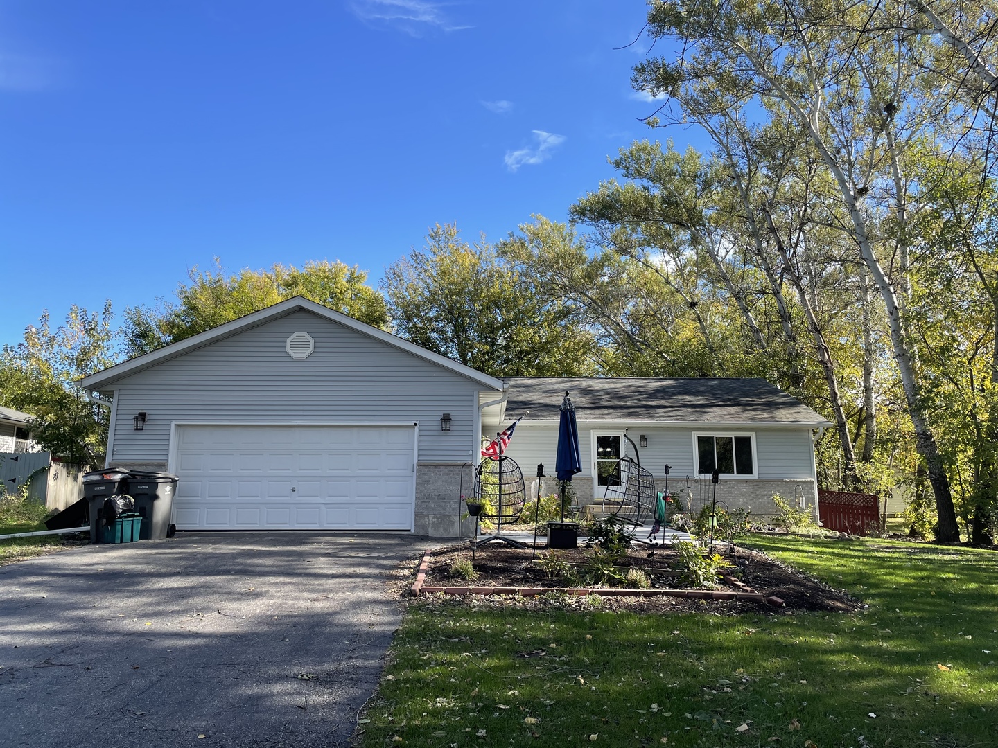 a view of house with backyard and outdoor seating