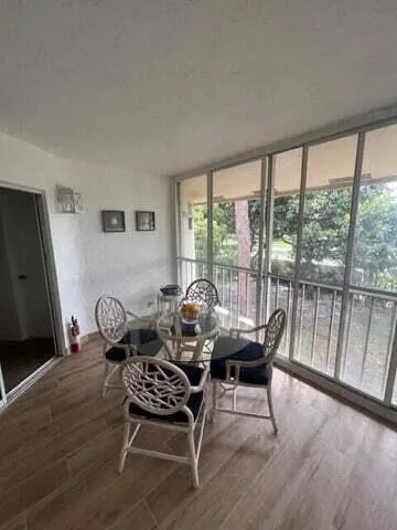 a dining room with furniture and wooden floor