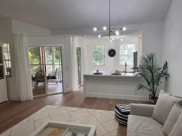 a view of living room with furniture and a chandelier