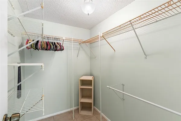 an empty room with closet and fan