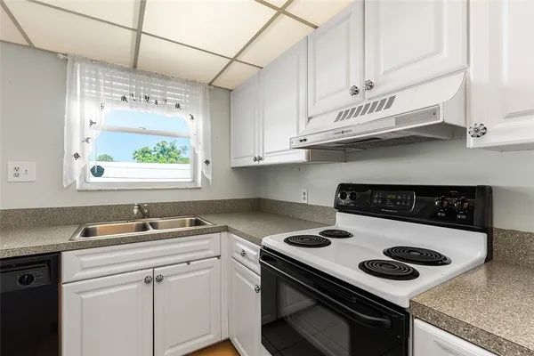 a kitchen with a stove and a sink
