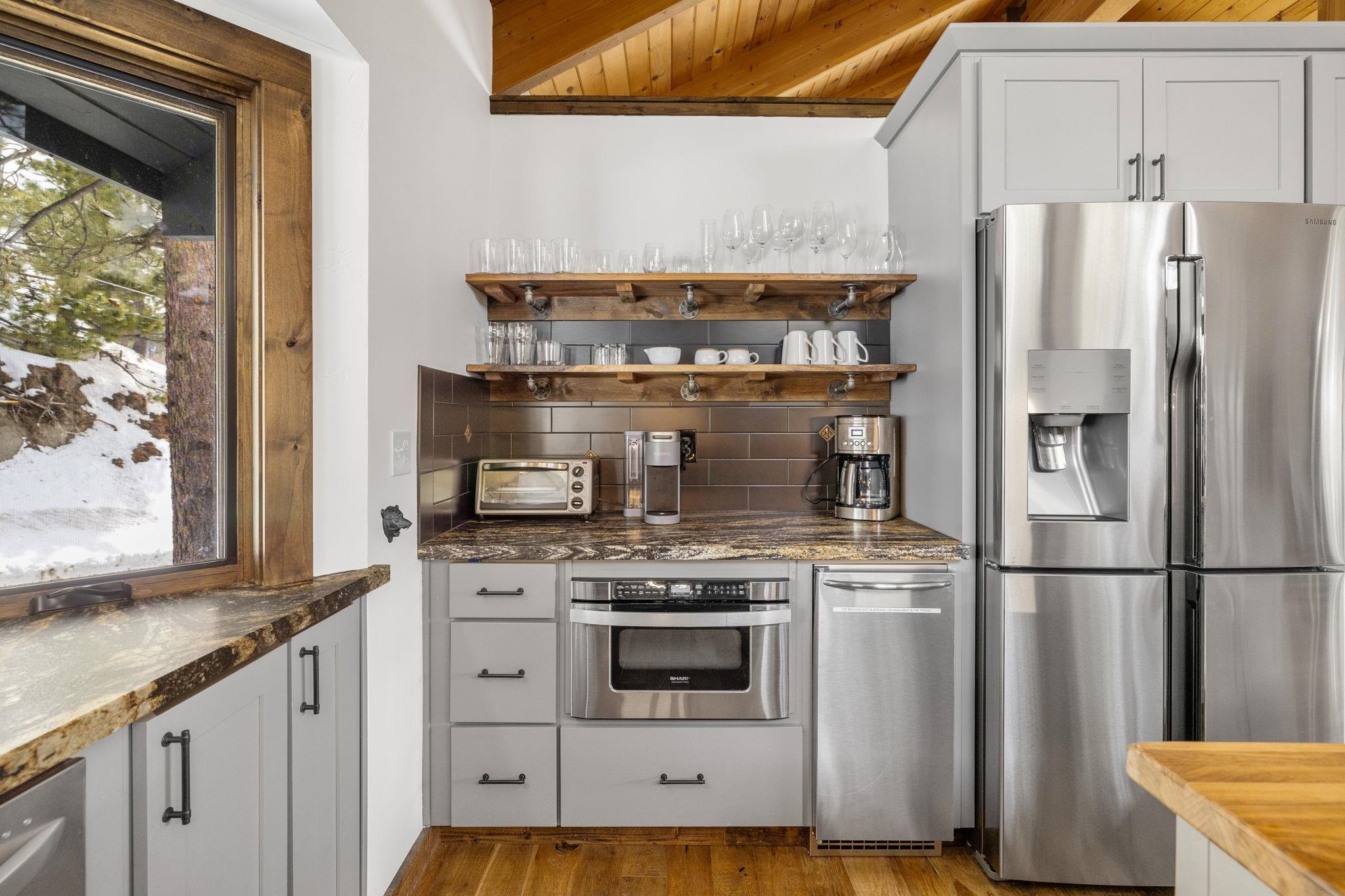 520 Laurel Lane Stateline, NV 89449 - Photo 2 of 27 a kitchen with granite countertop a stove and a refrigerator