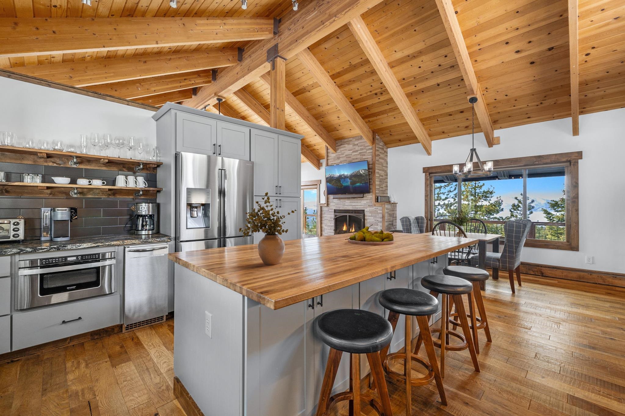 520 Laurel Lane Stateline, NV 89449 - Photo 10 of 27 a kitchen with stainless steel appliances granite countertop a kitchen island a stove a table and chairs